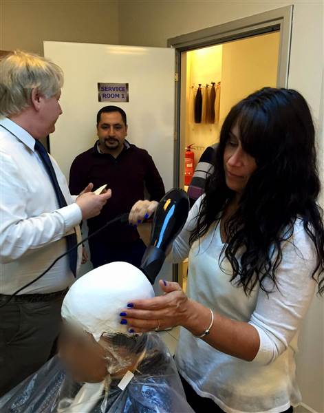 Transitions Hair Solutions owner Danielle Marzella makes a mold during a training in Europe.
